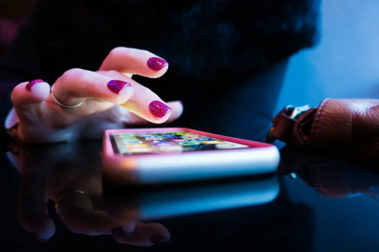 A person using a smartphone with apps displaying money making and financial earning tools