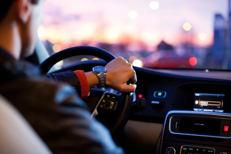 Driver holding steering wheel representing auto insurance coverage
