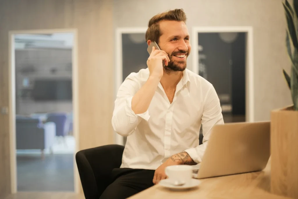 An entrepreneur in a suit sitting in an office workspace and represent Who Is an Entrepreneur