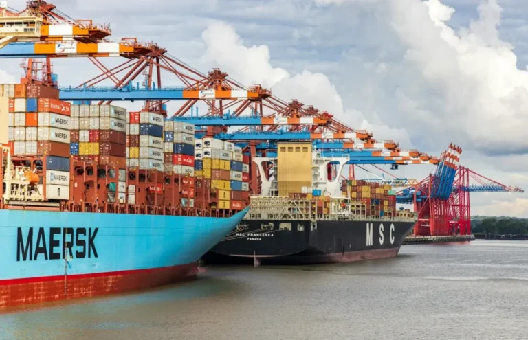 International cargo ship carrying containers, illustrating what is international trade and global shipping