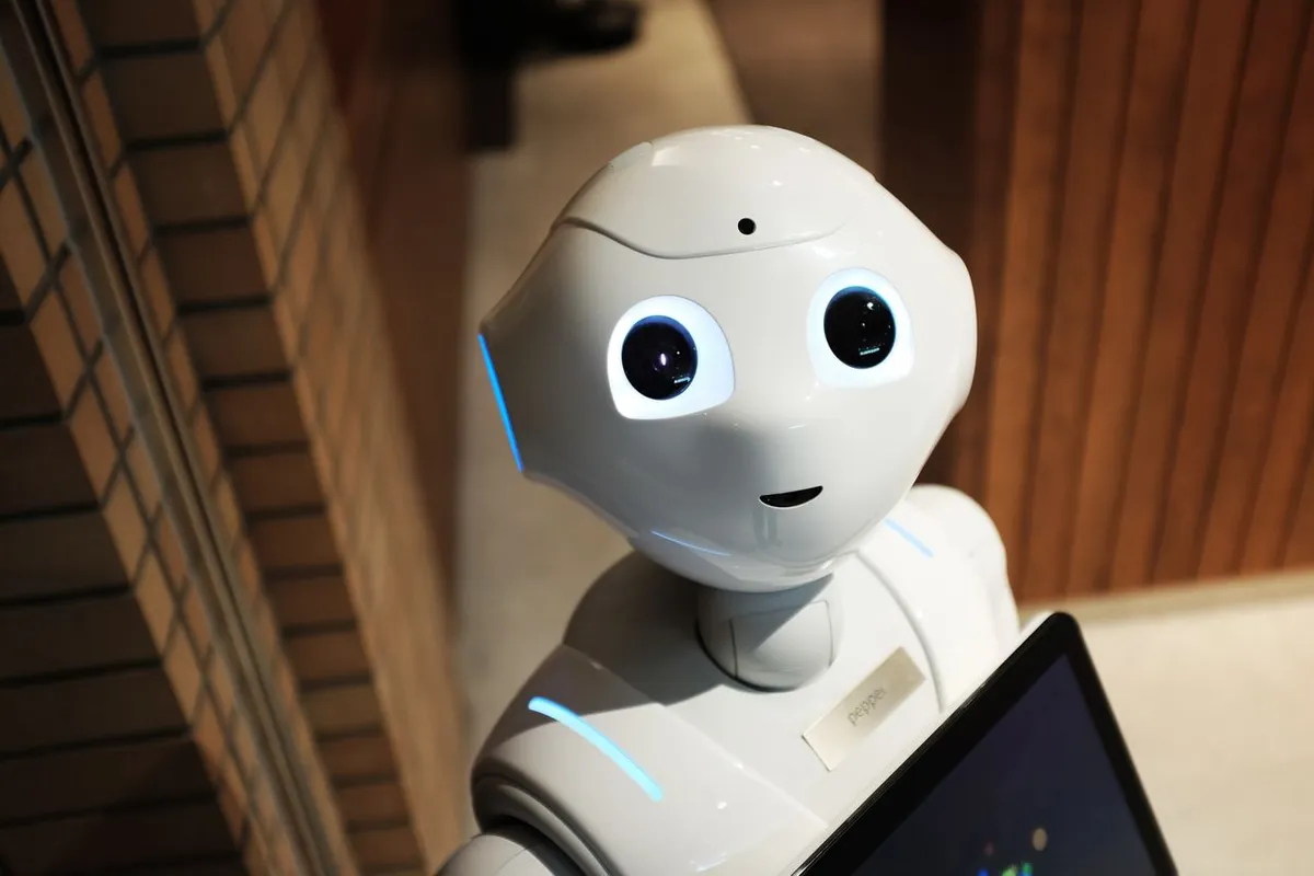 A cute, humanoid service robot looking forward, representing AI vs Machine Learning vs Deep Learning concepts