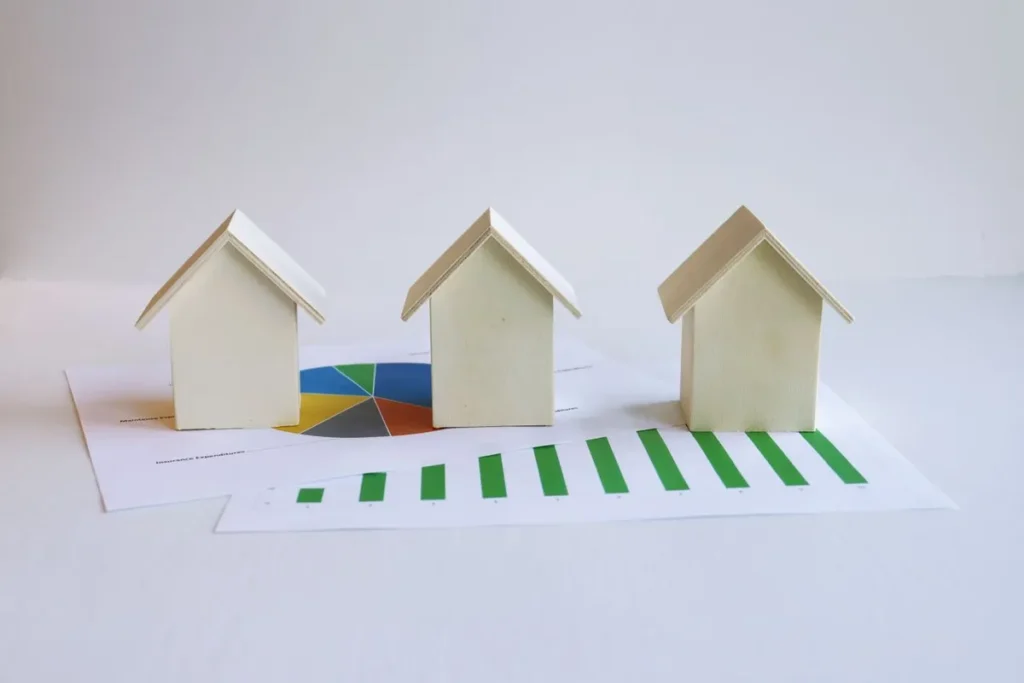 Small house models illustrating Real Estate Investing and property ownership