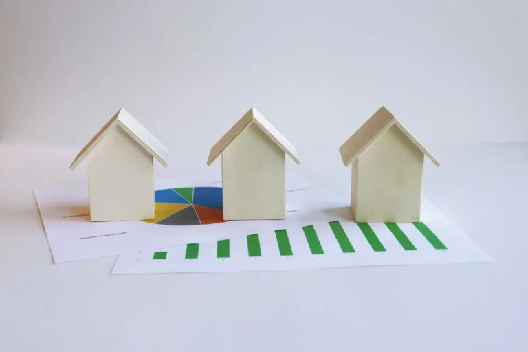 Small house models illustrating Real Estate Investing and property ownership