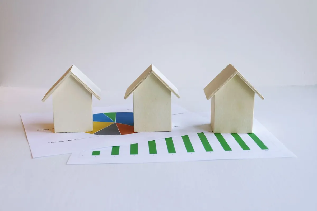 Small house models illustrating Real Estate Investing and property ownership