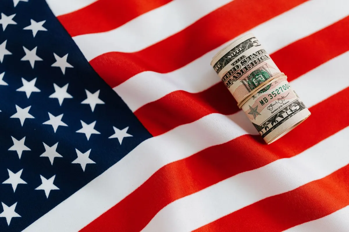 US flag placed near a container ship and international shipping logistics background for an article titled "What Are Free Trade Agreements?".