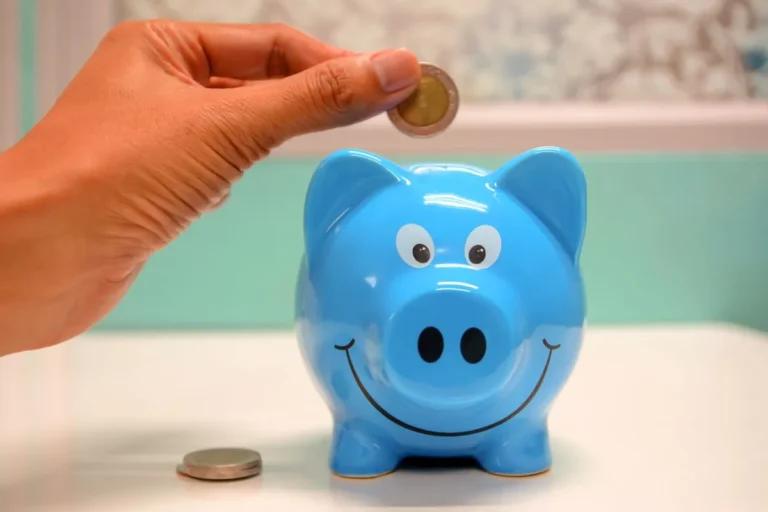 An image depicting the concept of "What Is Saving," showing hands placing coins into a blue piggy bank.
