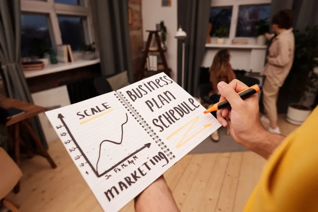 A business team planning strategies on a glass board representing What Is a Business Plan