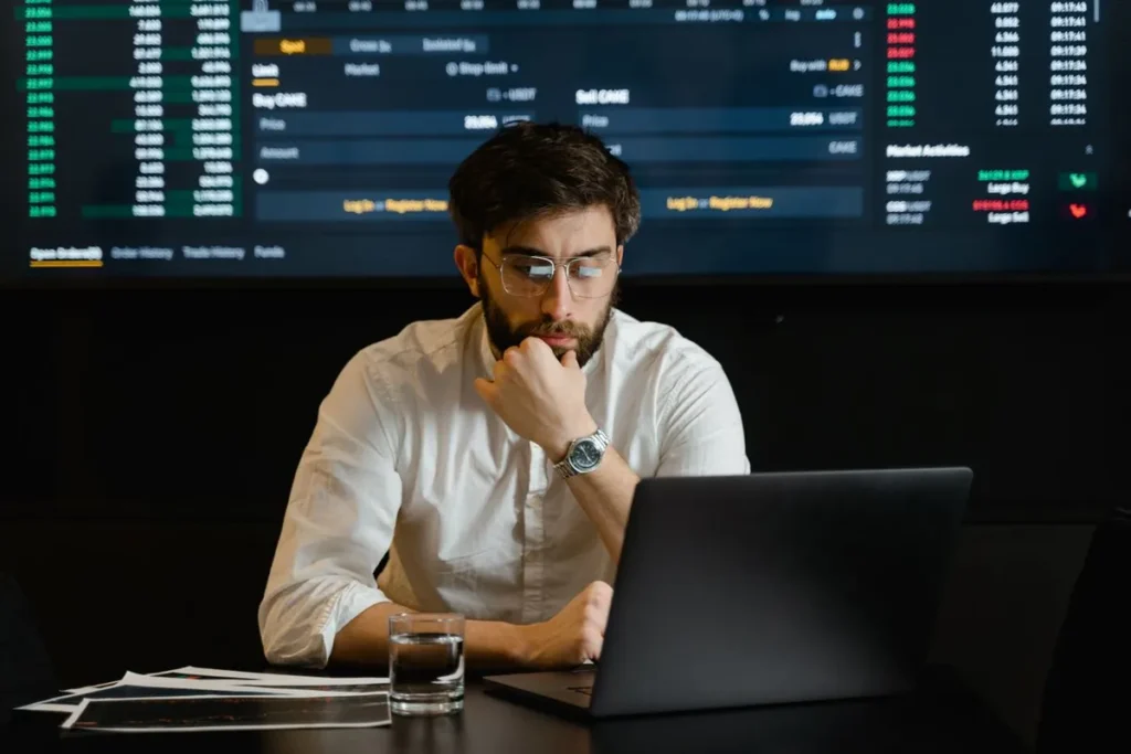 A person analyzed financial charts and data on a tablet, featuring the overlay text: "Who Is an Investor?"