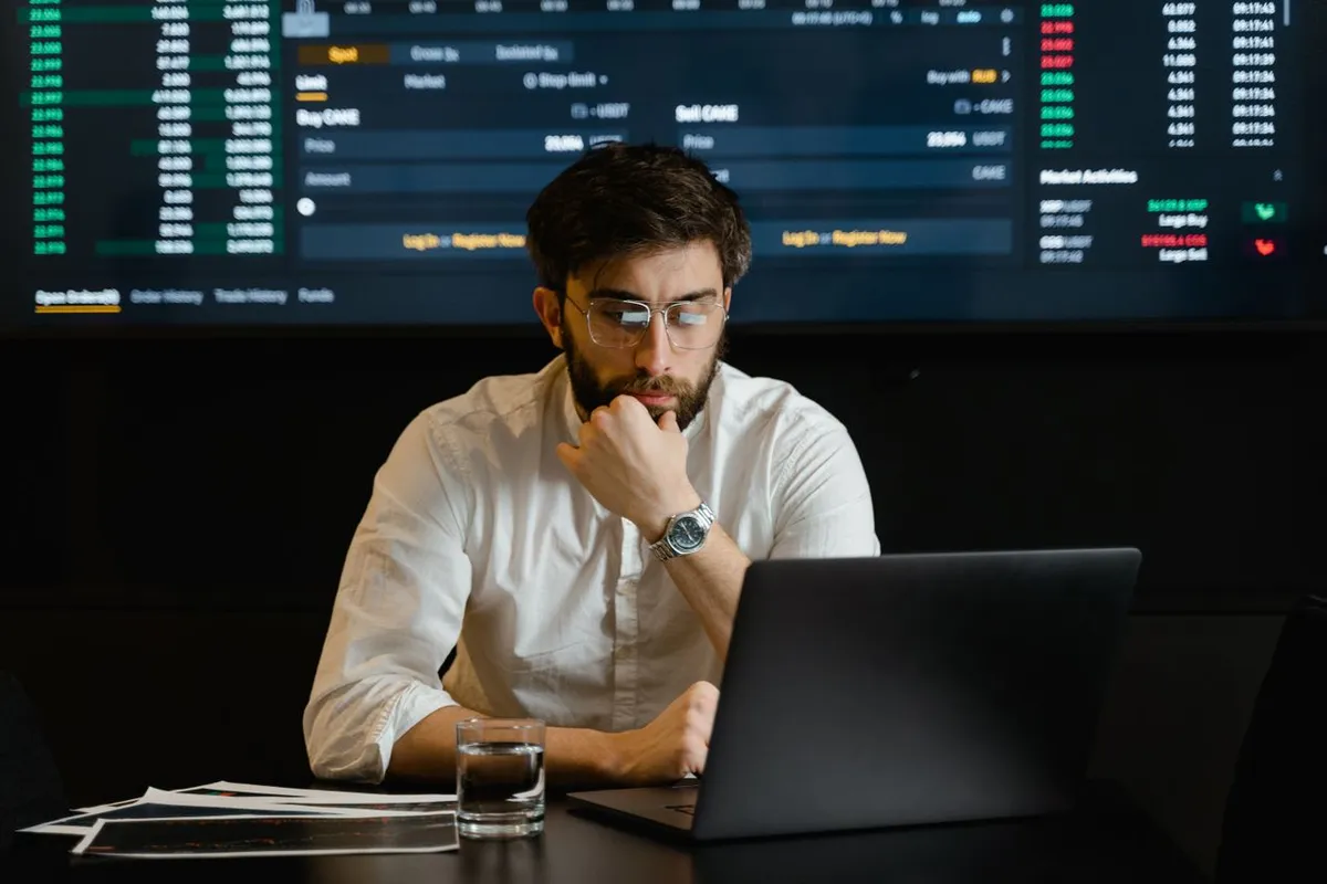 A person analyzed financial charts and data on a tablet, featuring the overlay text: "Who Is an Investor?"