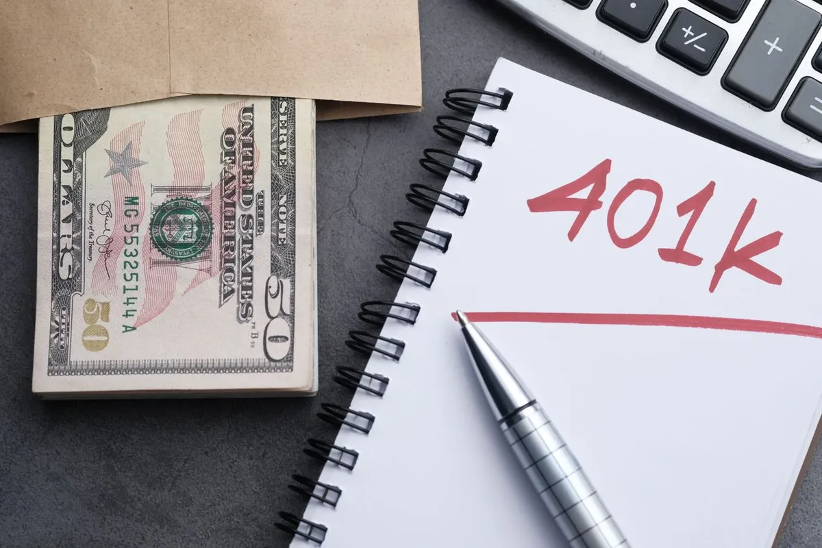 A notepad displaying 401k text next to cash and financial documents, explaining what is a 401(k) and workplace retirement plans.
