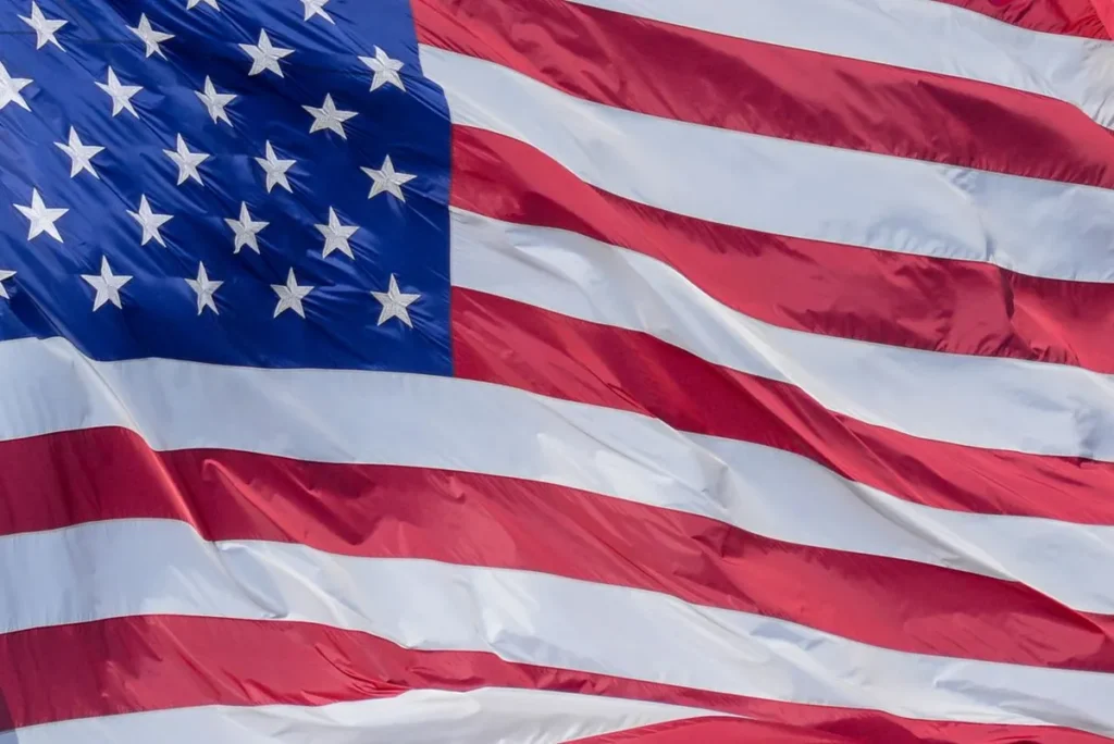 US flag waving in front of the Capitol building representing the U.S. national debt