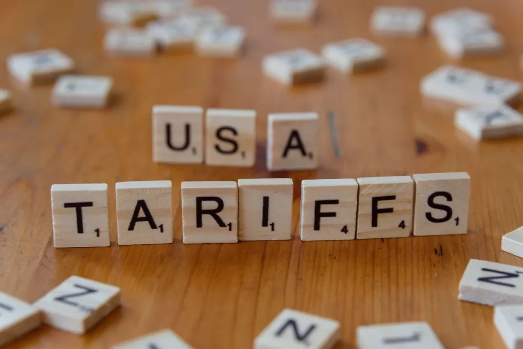 us tariffs letter blocks on world map background illustrating global trade