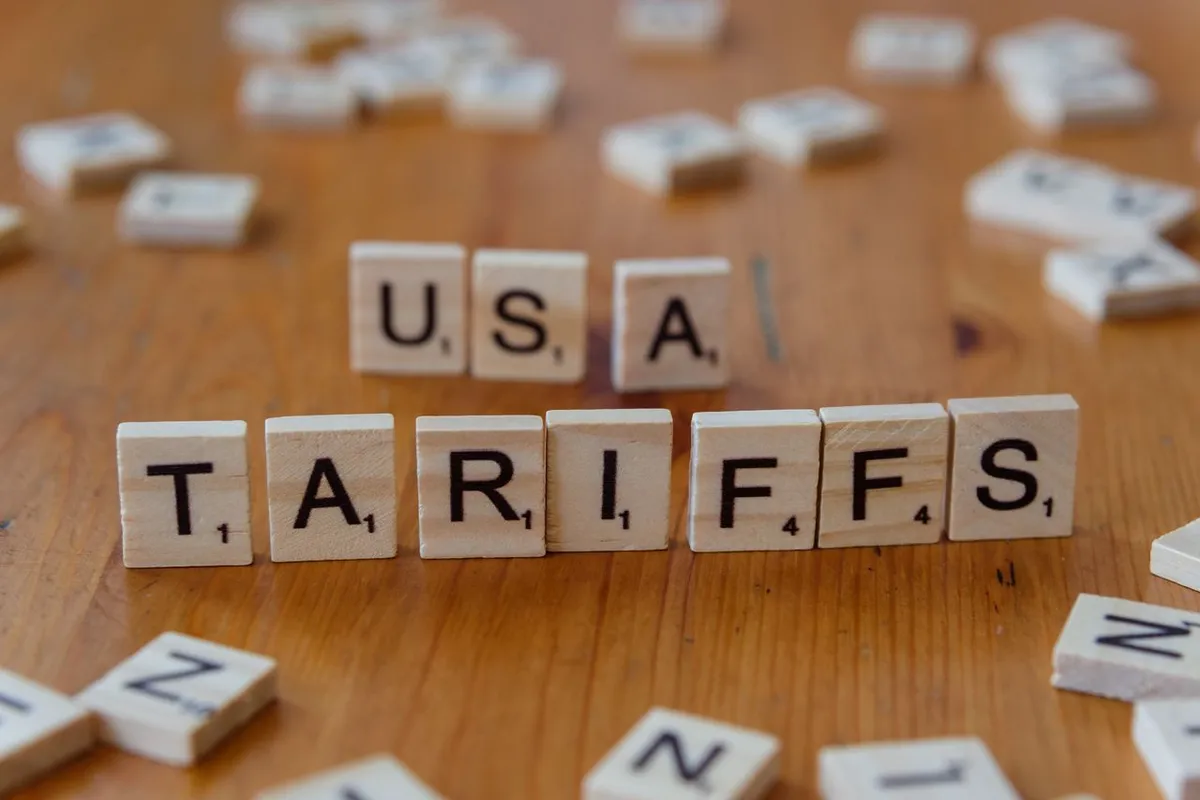 us tariffs letter blocks on world map background illustrating global trade