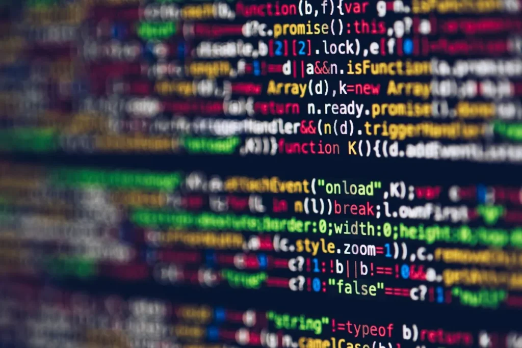 Green computer code scrolling on a dark screen, representing code development for Web3 applications