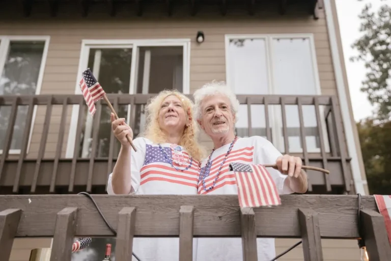 Destination Retirement US: Happy older adults discussing retirement plans together in a comfortable home environment.