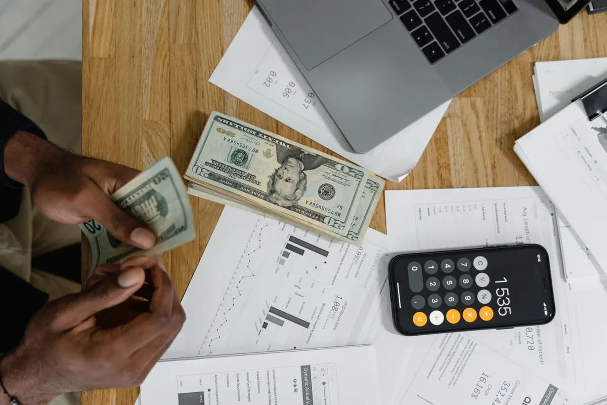 Financial documents and house key on table illustrating how interest rates affect loans