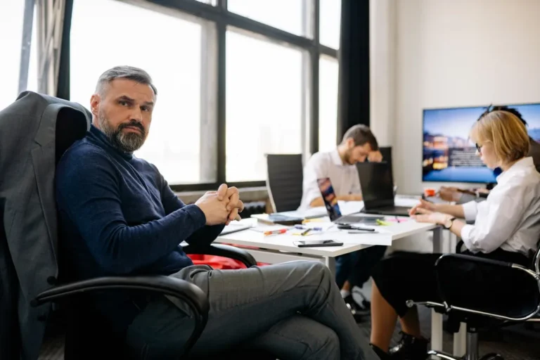 Business professionals collaborating in a modern boardroom illustrating how successful companies built wealth