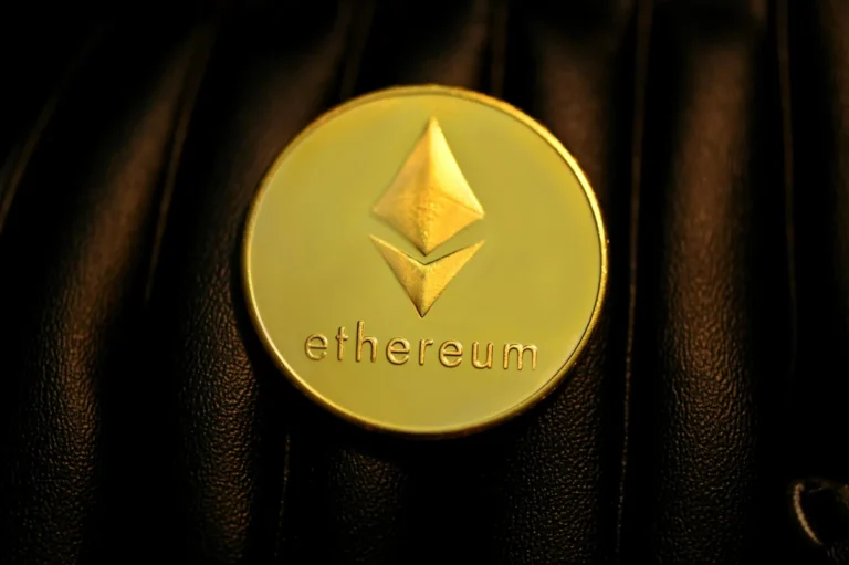 What Is Ethereum? - A glowing Ethereum token resting on a dark surface representing decentralized programmable blockchain infrastructure.
