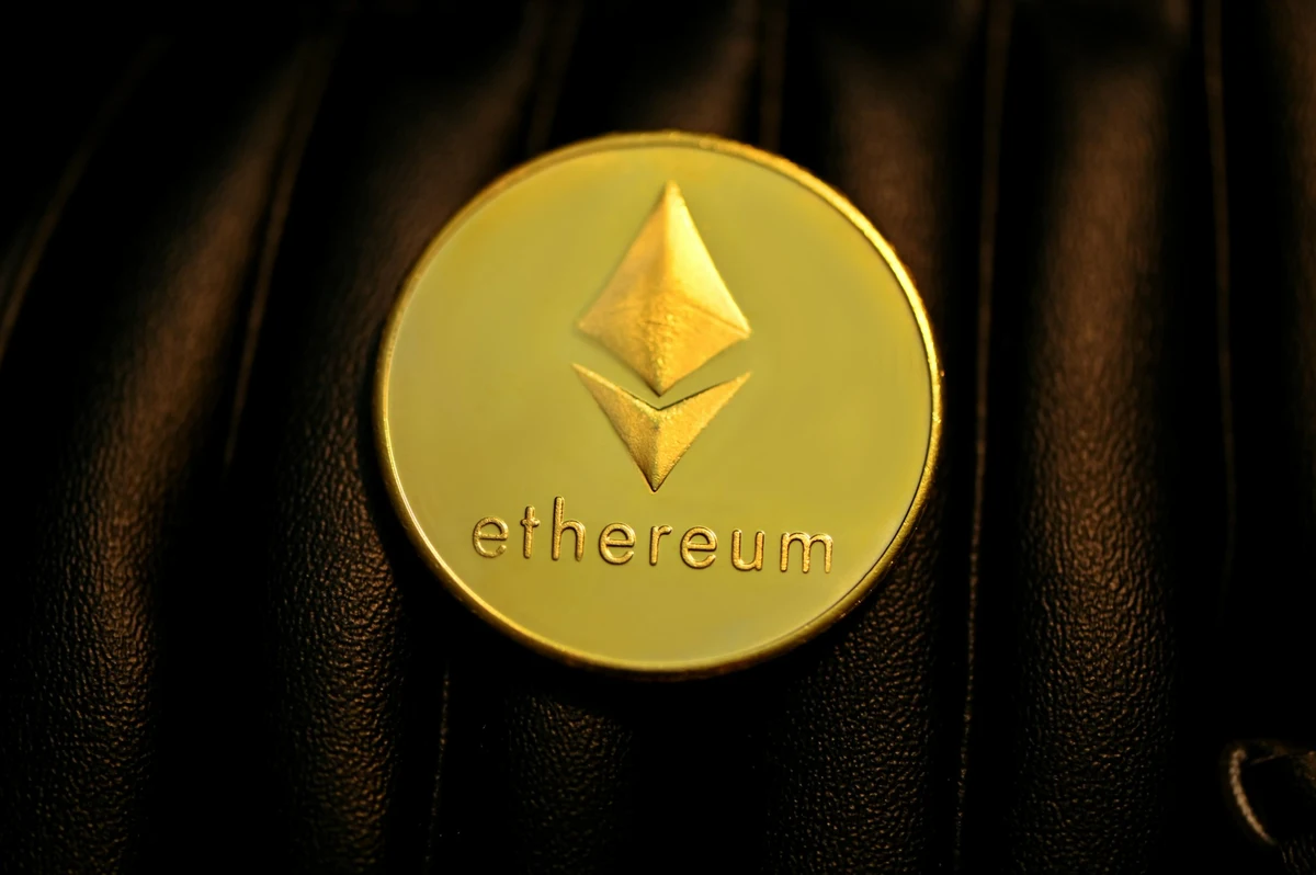 What Is Ethereum? - A glowing Ethereum token resting on a dark surface representing decentralized programmable blockchain infrastructure.