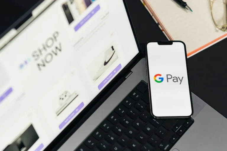 What Is Google Pay? Person making a contactless payment using a smartphone with the Google Pay interface at a terminal.