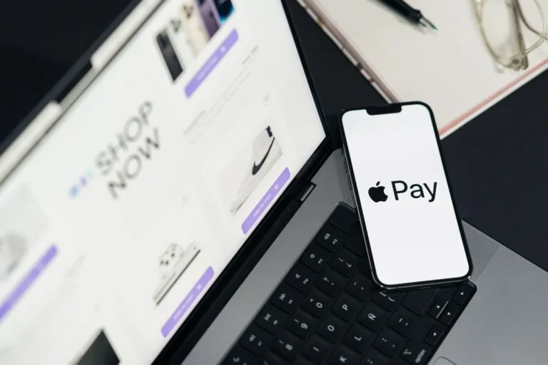 What Is Apple Pay? Smartphone displaying an Apple Pay contactless payment screen next to a physical credit card.