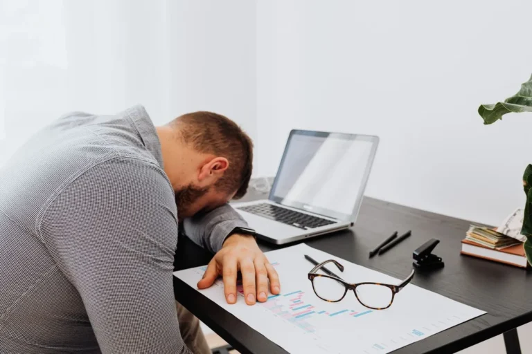 An investor reviewing financial reports and paperwork related to real historical commodity investment mistakes in gold, silver, and oil markets.