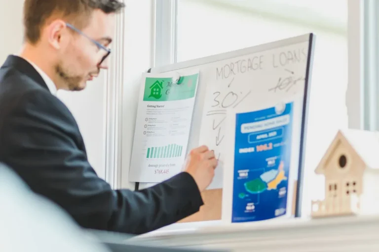 What are mortgage rates? Person reviewing home loan papers and calculations while discussing financing options with a lender.