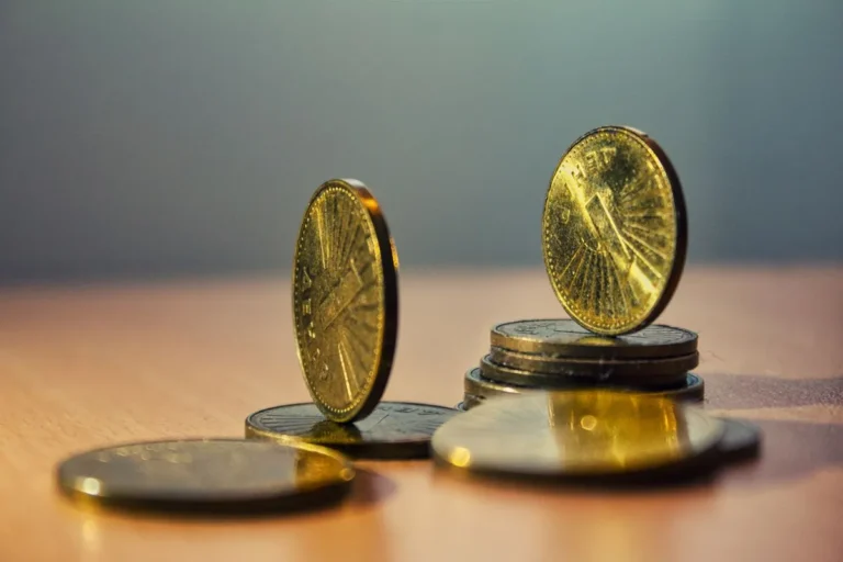 What Is Economic Stability? Stack of coins on a table, representing financial balance, asset security, and steady macroeconomic conditions.